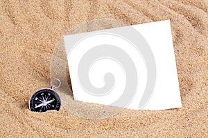 Compass in the sea sand on beach background with copy space for add text message or use components for design. Summer Travel