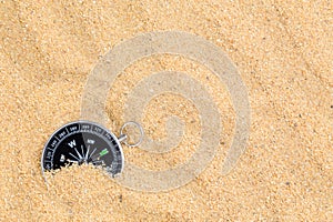 Compass in the sea sand on beach background with copy space for add text message or use components for design. Summer Travel