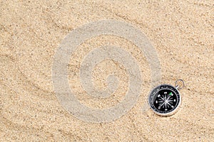 Compass in the sea sand on beach background with copy space for add text message or use components for design. Summer Travel