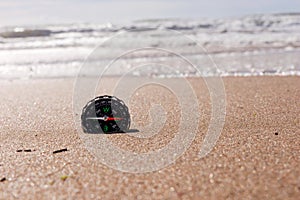 Compass on the sea sand at the beach