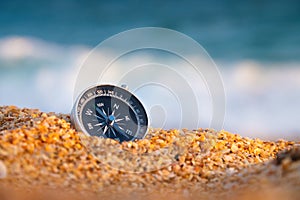 compass on sea sand and place for text. close up of navigation device on sandy beach without people, top view