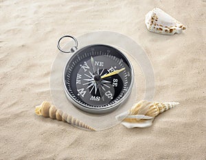 Compass on sea sand. Travel destination and navigation concept