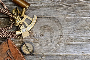 Compass,sextant and spyglass on the timber