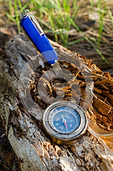 Compass and survival knife on an old rotten stump.A tool for Hiking and survival.