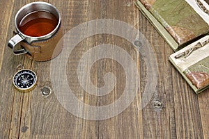 Compass, Tea Mug and Two Notebooks on Wood Table