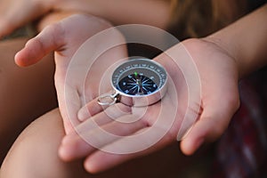 Compass in the teenagers hands. Adventure, travel, tourism concept