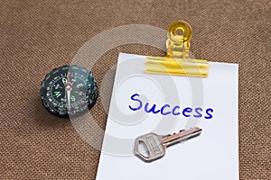 Compass with text success in business concept and key background