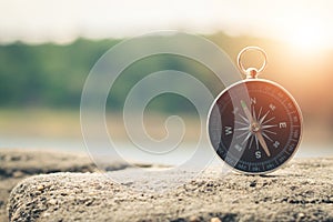 Compass of tourists on mountain at sunset sky