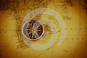 Compass on vintage world map. Retro style