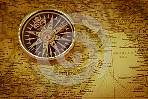 Compass on vintage world map. Retro style