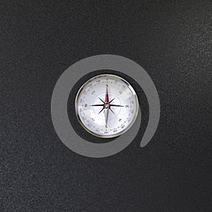 Compass with wind rose over black background view from the top