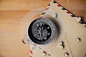 Compass on wooden background with space for text