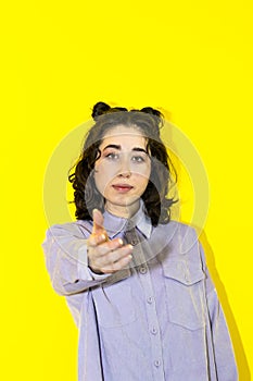 compassionate young latin woman isolated on yellow background offers for help, reaching hand of hand to the camera