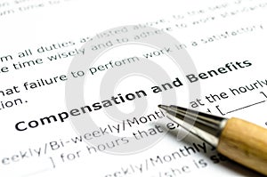 Compensation and benefits with wooden pen photo