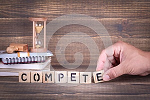 Compete. wooden letters on the office desk