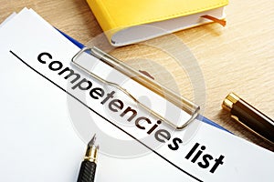 Competencies list with clipboard on a table. photo