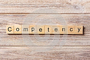 Competency word written on wood block. Competency text on table, concept