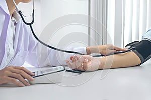 Competent attentive doctor being measuring blood pressure to pat