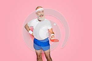 Competetive emotional cool active comic grandpa with beaming grin, with table tennis equipment. Healthcare, weight loss