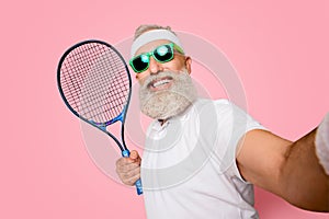 Competetive emotional cool grandpa with humor grimace exercising holding equipment, shoting photo. Body care, healthcare