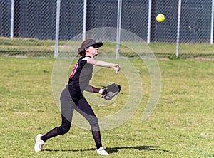 Competing in high school softball game