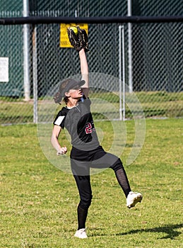 Competing in high school softball game