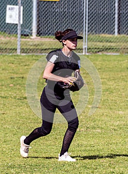 Competing in high school softball game