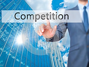 Competition - Businessman click on virtual touchscreen.