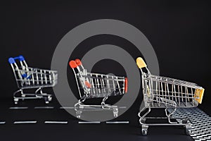 Competition concept. Shopping carts racing towards finish line