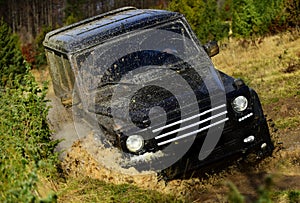 Competition, energy and motorsport concept. Off road vehicle or SUV overcomes obstacles. Auto racing on fall nature