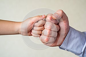 competition and victory, a fist of a child and an adult male close-up. Leader and winner