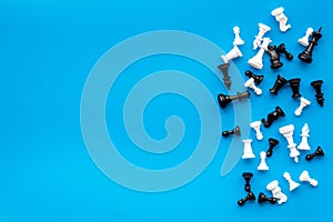 Competition or victory or strategy concept. Chess figures on blue background top view copy space