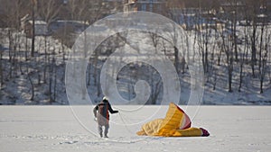 Competitions of paraglider pilots on the frozen lake. Ternopil Ukraine