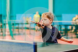 Competitions in table tennis, the child is playing table tennis