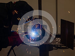 Competitions among welders. A man in a protective mask is welding. photo