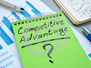 Competitive advantage sign on a green notepad.