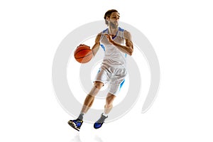 Competitive athlete practicing, basketball player in uniform in motion with ball isolated on white background