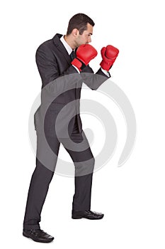 Competitive businessman in boxing gloves