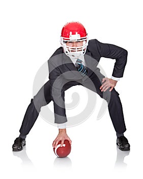 Competitive businessman playing american football photo