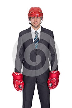 Competitive businessman wearing hockey equipment
