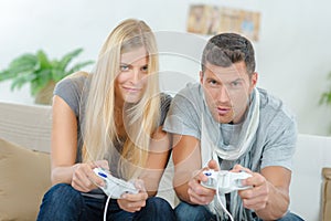 Competitive couple playing video games photo