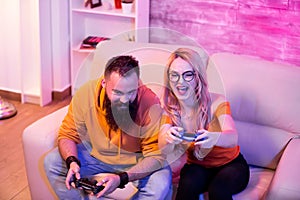 Competitive couple playing video games on console