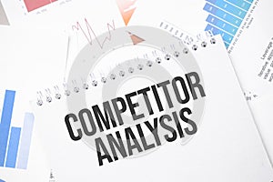 COMPETITOR ANALYSIS text on paper on the chart background with pen