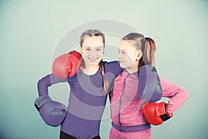 Competitors on ring and friends in life. Boxer children in boxing gloves. Confident teens. Female boxers. Boxing provide