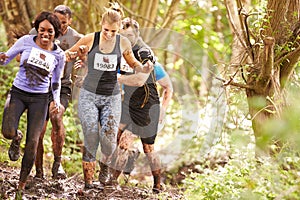 Competitors running in a forest at an endurance event photo