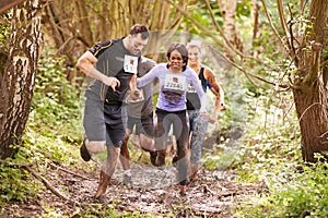 Competitors running in a forest at an endurance event photo