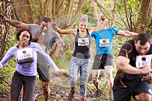 Competitors running in a forest at an endurance event photo