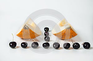 Compisition on white background with fruit. Melon and cherrys