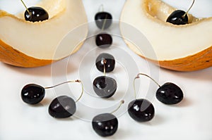 Compisition on white background with fruit. Melon and cherrys