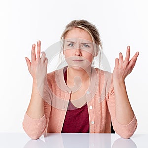 Complaining young blond woman expressing herself with angry hands up